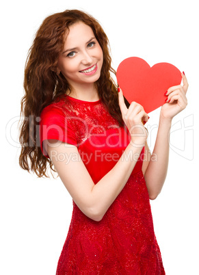 Young woman holding red heart