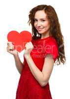 Young woman holding red heart
