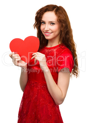 Young woman holding red heart