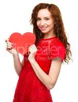 Young woman holding red heart