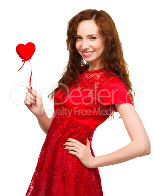 Young woman holding small red heart