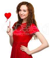 Young woman holding small red heart