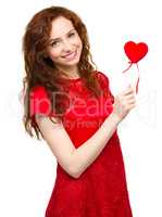 Young woman holding small red heart