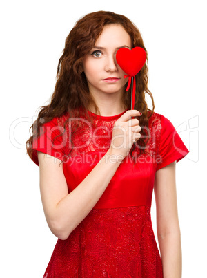 Young woman holding red heart