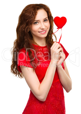 Young woman holding red heart