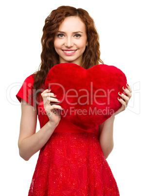 Young woman holding red heart