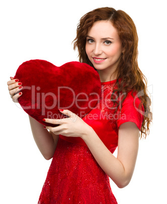 Young woman holding red heart