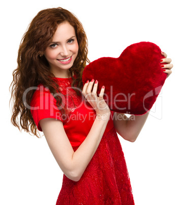 Young woman holding red heart