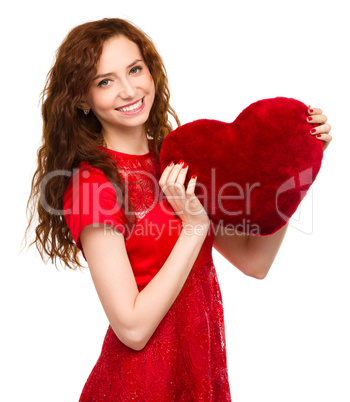 Young woman holding red heart