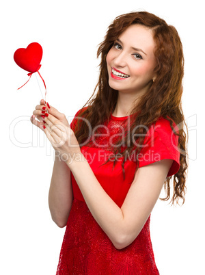 Young woman holding red heart