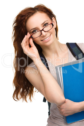 Young student girl is holding book