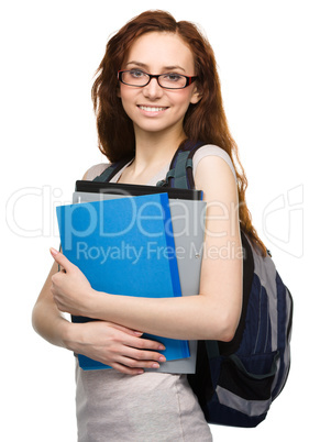 Young student girl is holding book