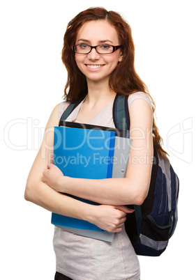 Young student girl is holding book