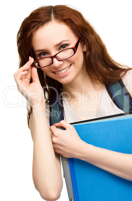 Young student girl is holding book