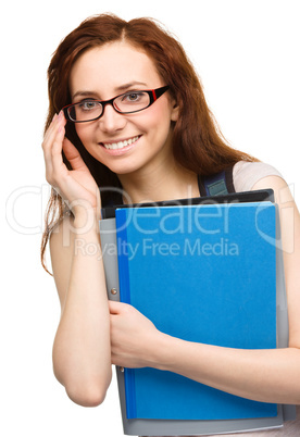 Young student girl is holding book