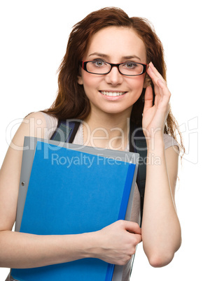 Young student girl is holding book