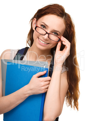 Young student girl is holding book