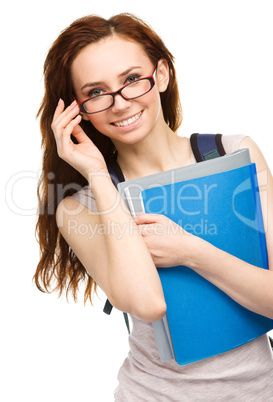 Young student girl is holding book