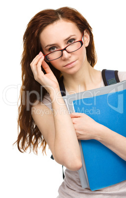 Young student girl is holding book