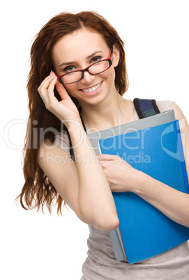 Young student girl is holding book