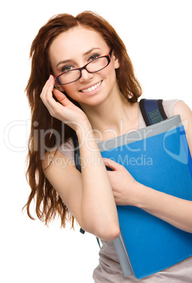 Young student girl is holding book