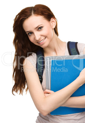 Young student girl is holding book