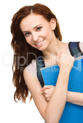 Young student girl is holding book