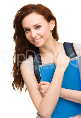 Young student girl is holding book