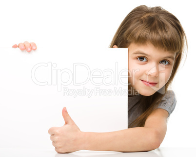 Little girl is looking out from the blank banner