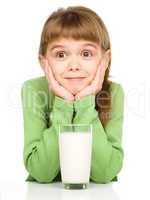 Cute little girl with a glass of milk