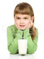 Cute little girl with a glass of milk