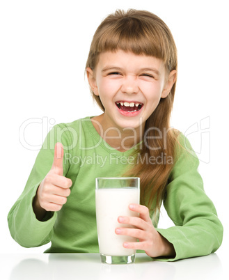 Happy little girl with a glass of milk