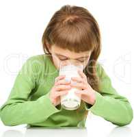 Cute little girl with a glass of milk