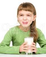 Cute little girl showing milk moustache