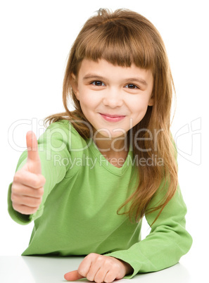 Little girl is showing thumb up sign