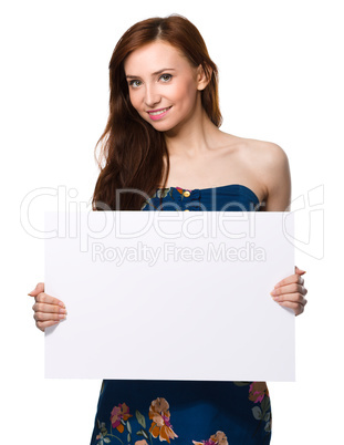 Young woman is holding blank banner