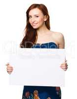 Young woman is holding blank banner