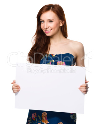 Young woman is holding blank banner