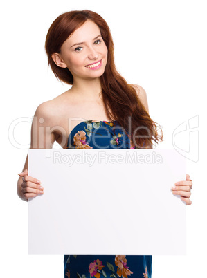 Young woman is holding blank banner