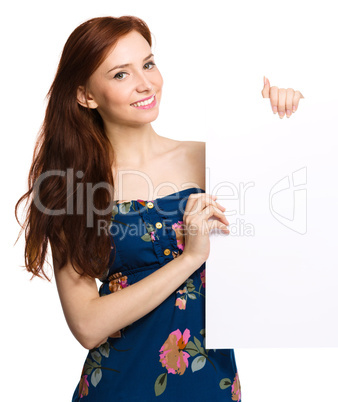 Young woman is holding blank banner