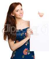 Young woman is holding blank banner