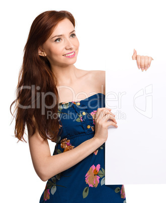 Young woman is holding blank banner