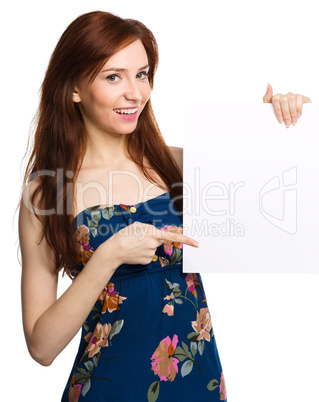 Young woman is holding blank banner