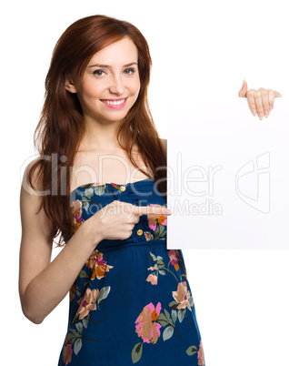 Young woman is holding blank banner