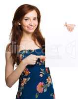 Young woman is holding blank banner