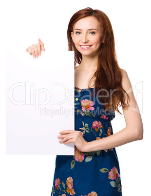 Young woman is holding blank banner