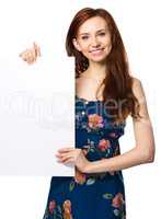 Young woman is holding blank banner