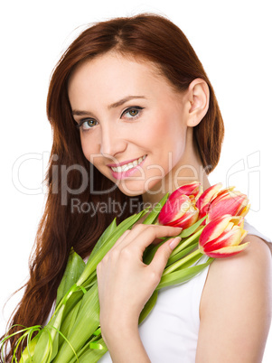 Young woman is holding bouquet of tulips