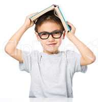 Little boy plays with book