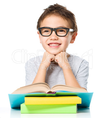 Little boy is reading a book